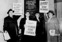 Men in topcoats and hats with rent increase protest signs.