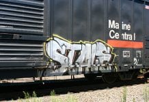Word "stale" spray-painted on side of train car.