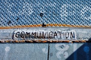 word communication stamped in metal