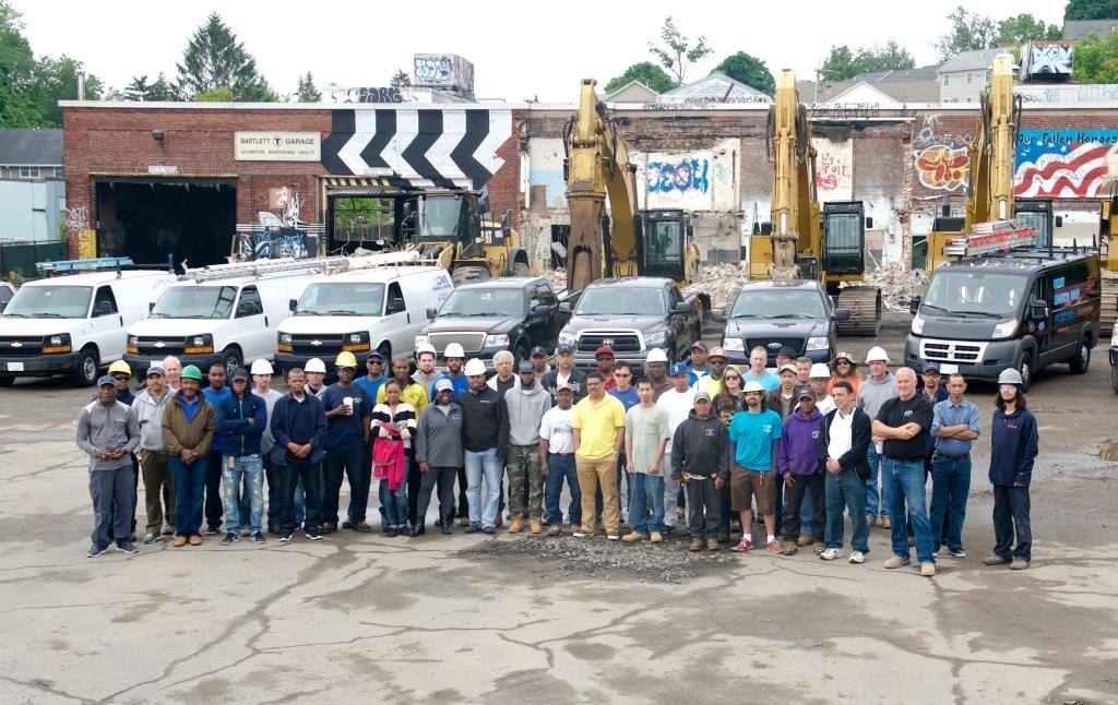 Contractors stand outside of the Bartlett Station development.