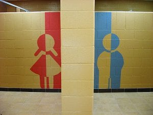 girl and boy symbols painted on a wall.