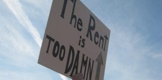 A sign that reads "the rent is too damn high."