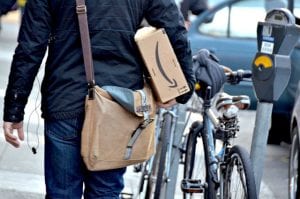 person holding Amazon delivery box