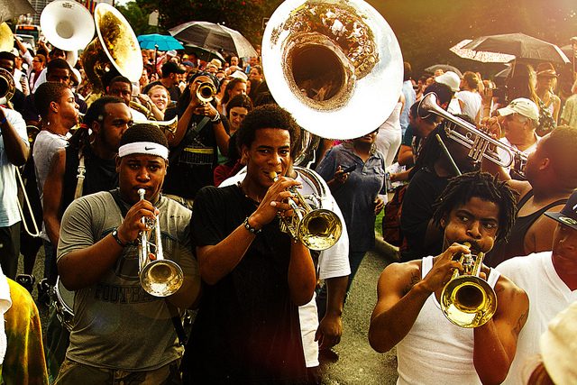 young men playing horn instruments