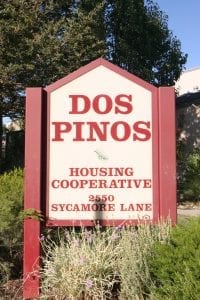 A red and white sign for the Dos Pinos Housing Cooperative in California. When this California housing cooperative began more than 30 years ago, it wasn’t the most affordable place to live. But now, it is.