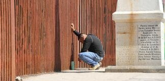 man at border fence