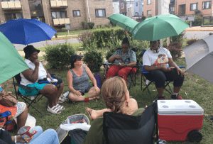 Residents in a mixed income area gather together outside.