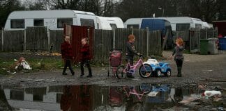 Children play on an Irish Traveller site on Dale Farm in 2011. A young boy with glasses rubs his eyes outside in Dale Farm, which was once the site of the largest Irish Traveller concentration until families were evicted in 2011. A health impact assessment helped house this indigenous group.