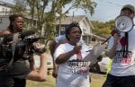 Kennetha Patterson of Homes for All in Nashville speaks on a megaphone during Renter’s Week of Action.