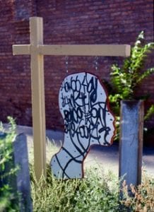A temporary hanging sign in the shape of participants’ silhouettes was public art in one neighborhood in Chicago.