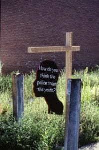 A temporary hanging sign in the shape of participants’ silhouettes was public art in one neighborhood.