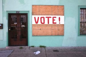vote sign on boarded window