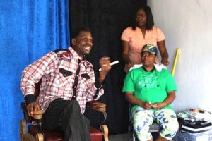 Actors perform a scene in a pop-up neighborhood barbershop. 