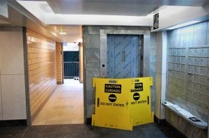 A yellow out of order sign blocks an elevator at the Ocean Bay Apartments complex.