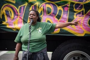 An Oakland activist speaks to local residents about a market-rate development that is slated for a vacant lot in the city. 