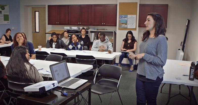 A woman leads a credit building class at Stephens Creek Crossing, a Hope 6 property owned and operated by Home Forward.