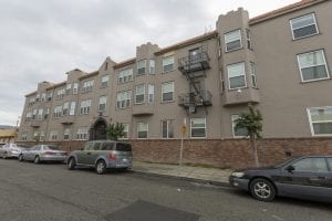 An exterior view of Kensington Gardens, a 41-unit apartment building in East Oakland. Several key organizations are working to take funding from health care systems to a new level.