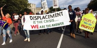 Boston residents participants marched to a nearby national gathering of YIMBYs with a sign that reads "Displacement is the Crisis ... We Are The Answer."