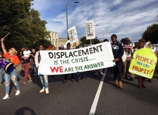 Boston residents participants marched to a nearby national gathering of YIMBYs with a sign that reads "Displacement is the Crisis ... We Are The Answer."