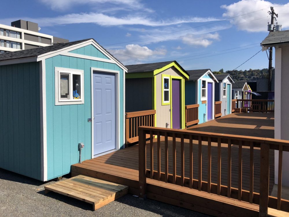 Six tiny houses share a common deck.