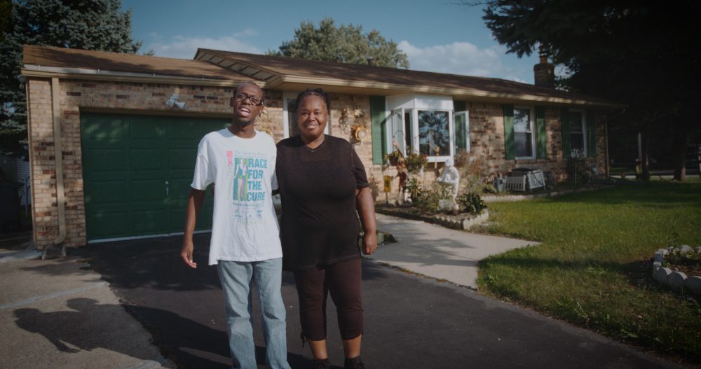 ProMedica and LISC have teamed up to improve health outcomes for residents, including for this Ohio family. The mother, at right, stands with her son in front of the new home she was able to purchase.