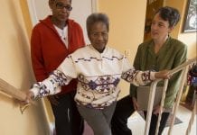 Two women help a senior go up the stairs to her home. Like Project Sustained Legacy, the CAPABLE program helps seniors age in place.