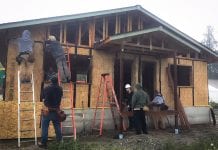 People work to build a home using an approach to create a passive house.