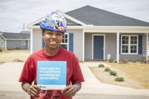 affordable housing woman in hard hat as part of the cost of home campaign.