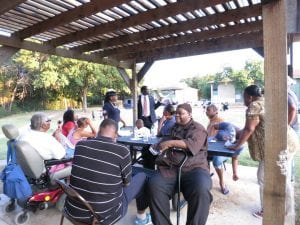 people gathered at an outdoor meeting. Their landlord was put on notice for interfering with the right to organize.