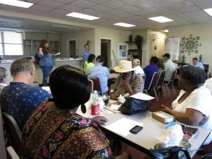 people seated at tables in a meeting