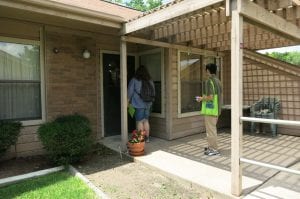 two people door knocking