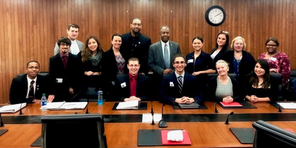 group photo of former foster care youth with HUD Secretary Ben Carson.