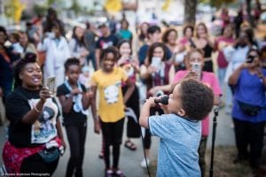 night out crowd watches child perform