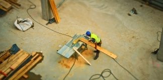 aerial view of construction worker sawing board