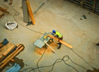 aerial view of construction worker sawing board