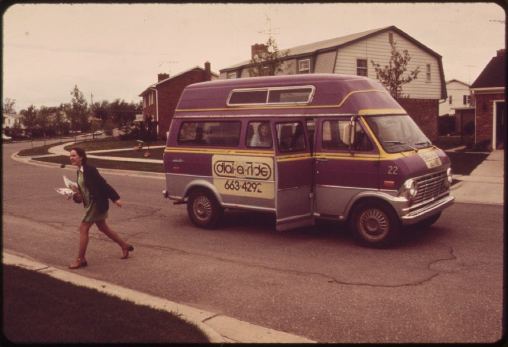 A passenger is dropped off by a dial-a-ride service in 1973. Services like this are also called microtransit.