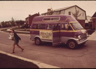 A passenger is dropped off by a dial-a-ride service in 1973.