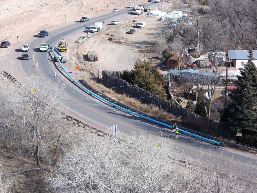 aerial view of water line under construction between two colonias; persistent poverty