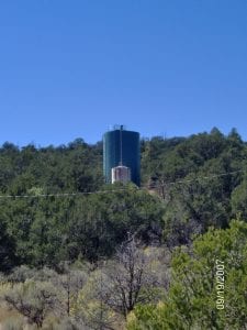 Anew water tank behind the old rusted tank in a colonia in the Southwest. Partners for Rural Transformation