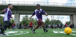 A young man prepares to kick a soccer ball during a youth soccer game.