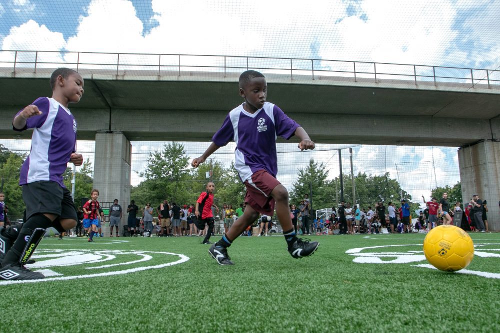 A young man prepares to kick a soccer ball during a youth soccer game.