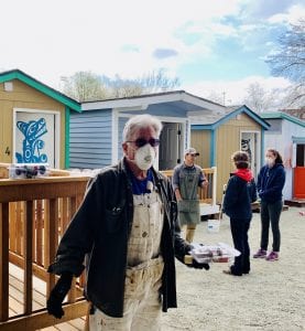 tiny houses during the pandemic. Image shows staff and volunteers at T.C. Spirit Village in Seattle