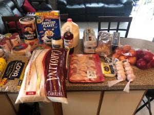 providing food in a pandemic. A table full of groceries to feed a family of four