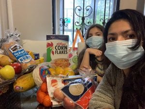 providing food in a pandemic. Volunteers with groceries from local supermarkets