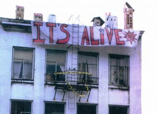 Squatters occupy the Arion building in Seattle after it sat vacant for months. There are signs that read "Operation Homestead" and "It's Alive" outside the large white building.