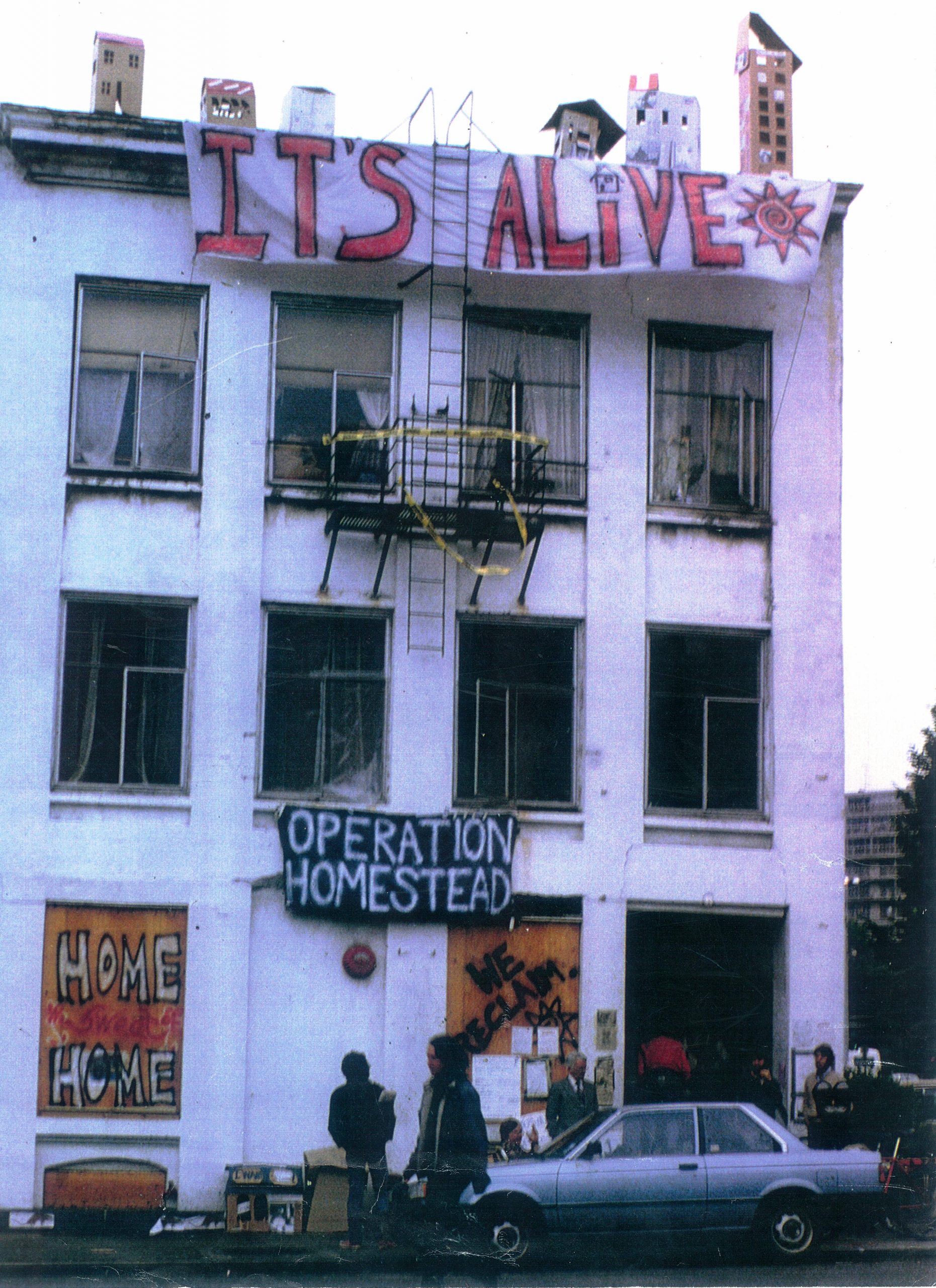 Squatters occupy the Arion building in Seattle after it sat vacant for months. There are signs that read "Operation Homestead" and "It's Alive" outside the large white building.