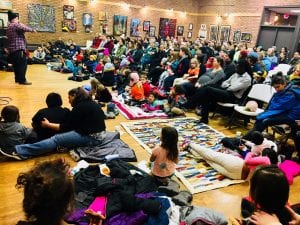 Community members attend a storytelling event hosted by AICHO. Photo courtesy of AICHO.