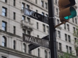 expanding CRA. Image shows Wall Street street sign