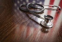 Stethoscope with American Flag Reflection on Table