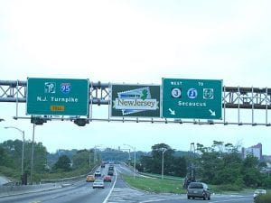 Image shows highway sign "Welcome to New Jersey"